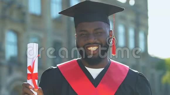 穿着文凭的黑人男生做着是的手势视频的预览图