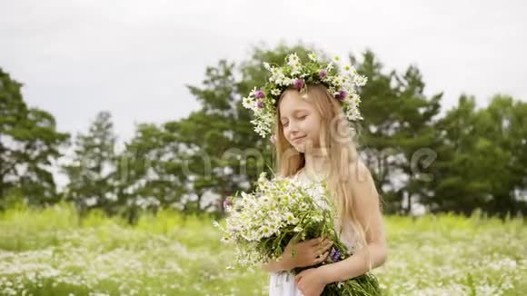 少女闭着眼睛头上戴花环花束在花丛中视频的预览图