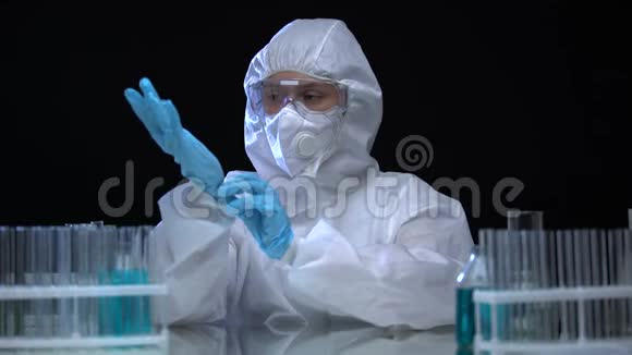 实验室助理穿着防护服研究带有病毒的试管视频的预览图