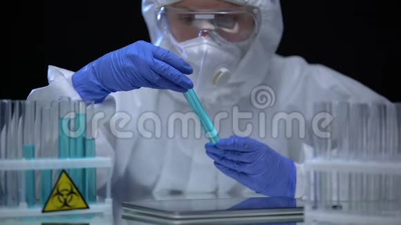 女性有毒实验室工作人员在平板电脑上做笔记分析生物危害液体犯罪视频的预览图