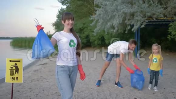 生态护理戴橡胶手套的快乐积极分子的肖像带垃圾袋近背景男性的指针标志视频的预览图
