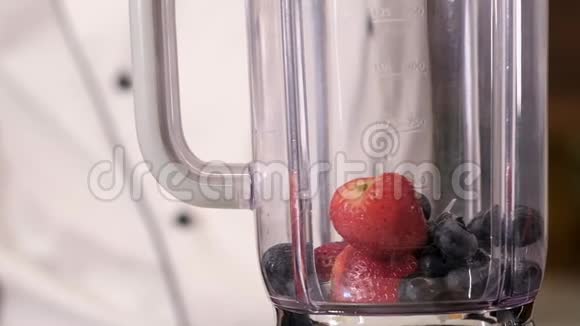 在厨房的搅拌机里做冰沙新鲜饮料健康视频的预览图