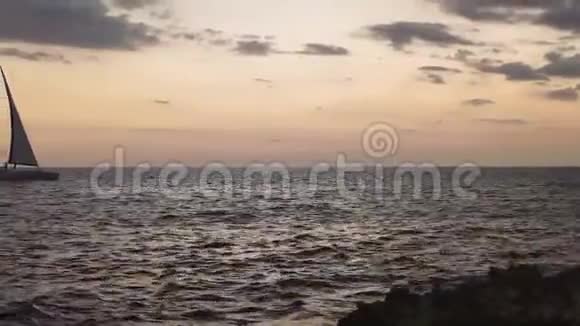 帆船在日落时驶过海面视频的预览图