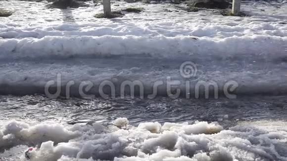 孩子们用融化的冰在泉水小溪边奔跑视频的预览图