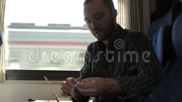聪明的休闲男子打开一次性耳机在火车上视频的预览图
