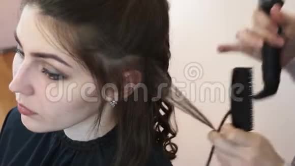 发型师把模特头发包在卷发铁上视频的预览图