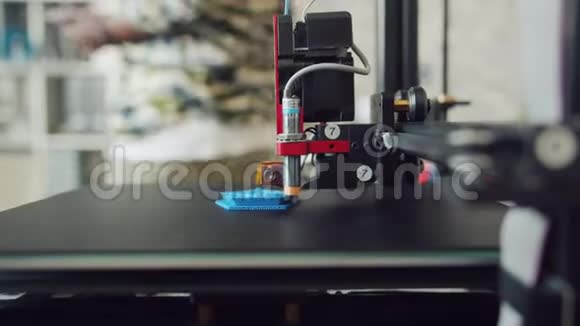 3D打印机制作塑料制品的特写镜头人在后台行走视频的预览图