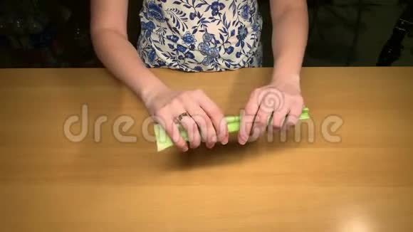 餐桌上的女孩从芹菜的外皮上清洗视频的预览图
