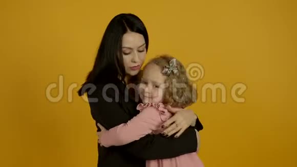 迷人的女人拥抱小卷曲的女儿视频的预览图