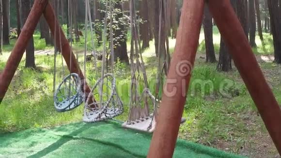 挂绳椅或在森林里的木制露台上荡秋千视频的预览图