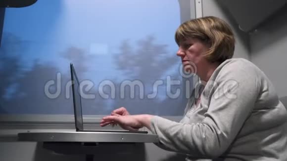 坐火车的女人拿着笔记本电脑视频的预览图
