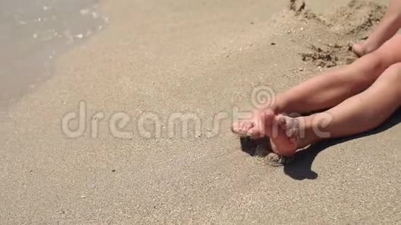一个小男孩在沙滩上脚特写慢动作视频的预览图