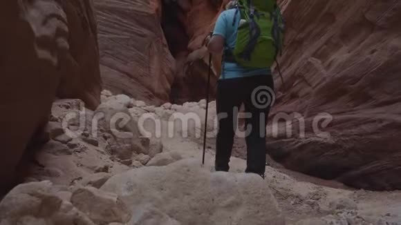 橙色岩石形成的深槽峡谷沙质河床旅游徒步旅行视频的预览图