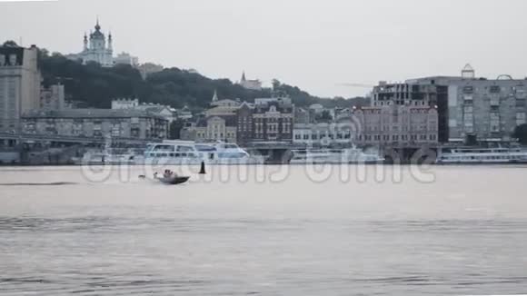 摩托艇在城市之间沿着河流快速漂浮小船在河上航行视频的预览图
