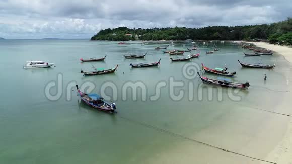 泰国普吉岛热带海洋美丽海滩的泰国传统长尾渔船鸟瞰图视频的预览图