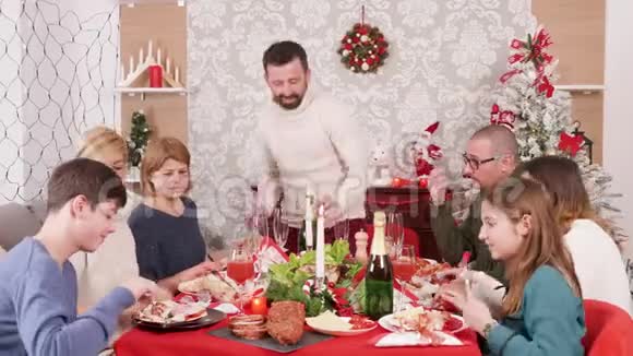 在圣诞盛宴上开一瓶香槟的男人视频的预览图