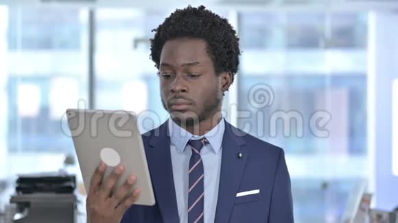 成功的非裔美国商人对平板电脑感到惊讶视频的预览图