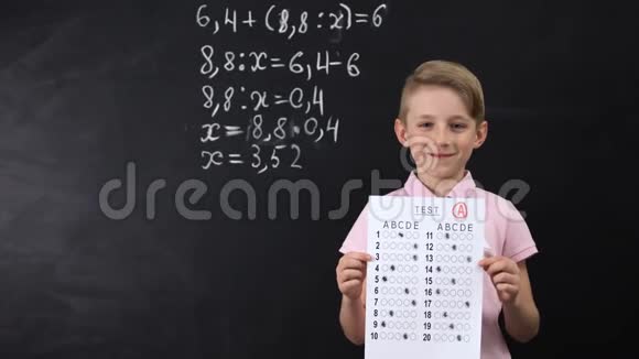 微笑的小学生表现出出色的测试数学练习写在后面视频的预览图