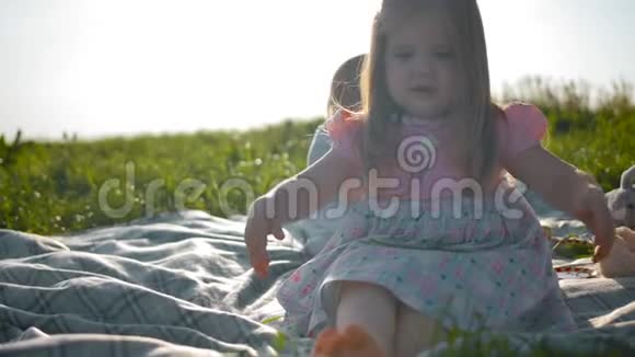 两个小妹妹坐在野餐的封面上视频的预览图