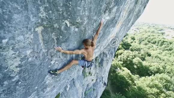 攀岩者在石灰石悬崖上攀爬大范围移动手里拿着绳索夹着视频的预览图