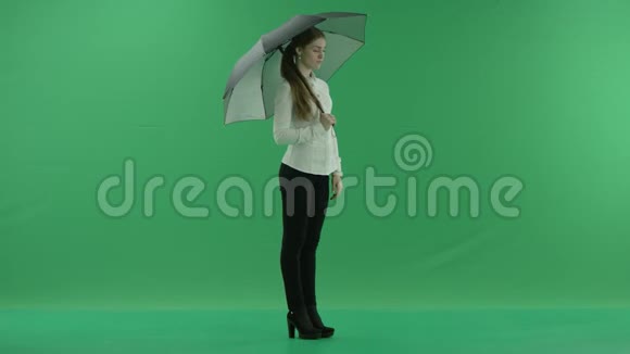 一个体贴的女人正在等待检查她站在右边伞在绿色的屏幕上她穿着正式的衣服视频的预览图
