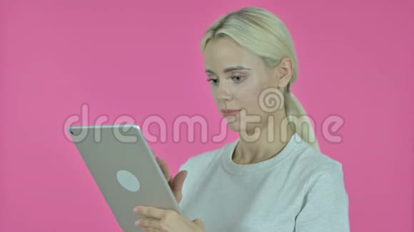 粉红背景下年轻女子桌上的视频聊天视频的预览图