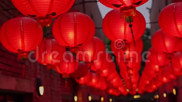 晚上走在中国传统的街道上挂着漂亮的圆红灯笼摇曳着农历新年的概念f视频的预览图