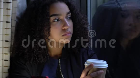 少女少女少女穿着黑色夹克坐在窗外喝着一杯咖啡视频的预览图