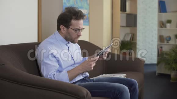 戴眼镜的男性在报纸上看坏消息危机失败者视频的预览图