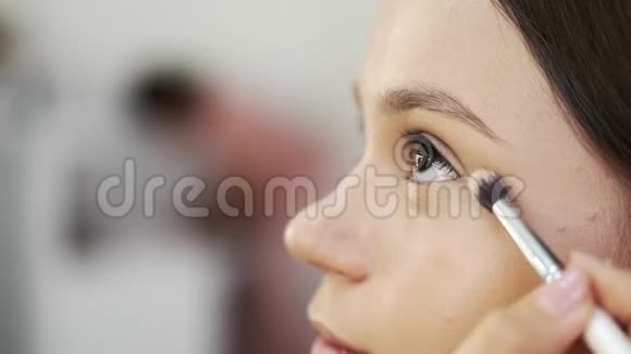 在美容院化妆时特写女性脸部视频的预览图