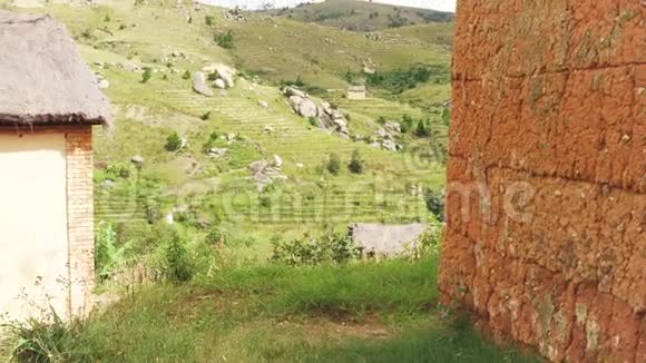 在马哈桑达附近的典型的马达加斯加房屋和景观上惊慌失措玉米和水稻生长在小山丘上视频的预览图