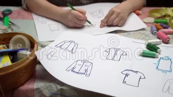 女设计师用纸画衣服草图视频的预览图