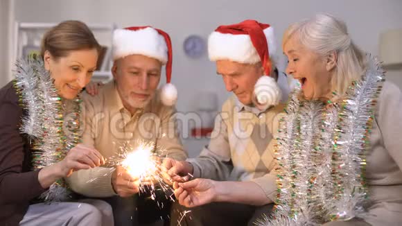 成熟的人点燃火花朋友庆祝新年和圣诞节视频的预览图