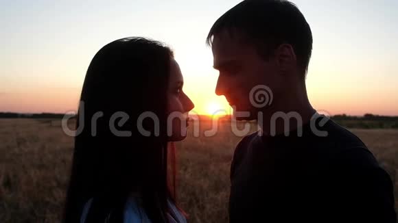 剪影在日落时亲吻相爱的情侣视频的预览图