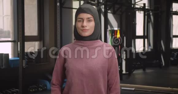 年轻迷人的穆斯林运动女性特写镜头双臂交叉在胸前微笑着看着镜头视频的预览图