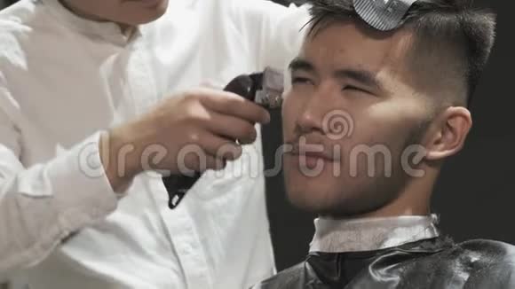 理发店一位满意顾客的特写做一个现代发型视频的预览图