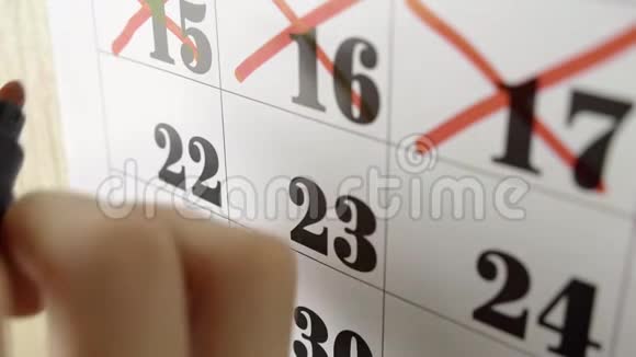 女性手用红色记号笔穿过日历日22慢镜头关门视频的预览图