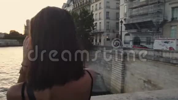 法国年轻女子在巴黎拍摄塞纳河的照片夜景视频的预览图