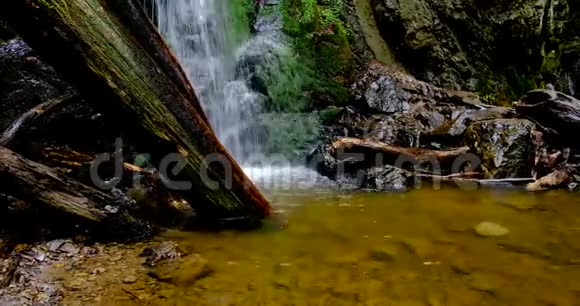瀑布般的水花泉水般的水落在岩石上覆盖着缓慢的淘沙视频视频的预览图