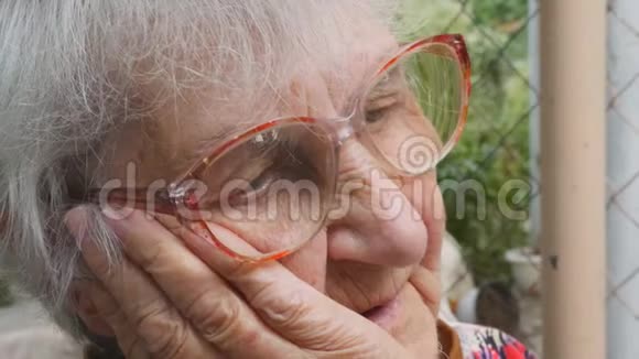 有情感和感情的祖母肖像老妇人带着悲伤的表情看着户外奶奶手牵手视频的预览图