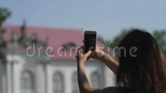 女游客正在用智能手机拍照视频的预览图