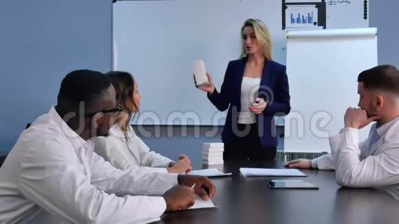 年轻女商人向医生赠送新药片或药片视频的预览图