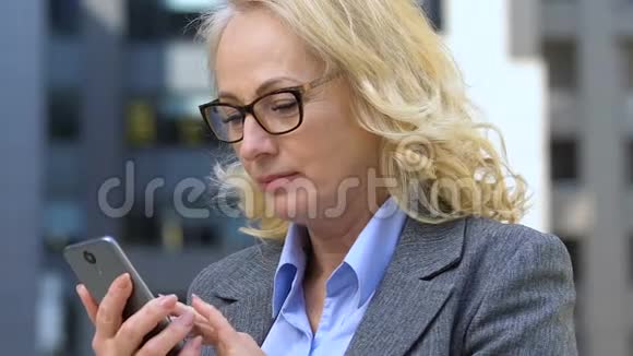 成熟的女士喜欢手机轻松的商务应用在线支付视频的预览图