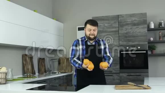 有趣的时刻快乐丰满的男人扔橘子胖子想耍花样笑笑体重超标的人视频的预览图