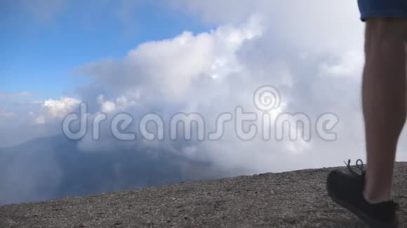 年轻的男性徒步旅行者背着背包登上山顶背景是多云的天空举起双手男子旅游视频的预览图