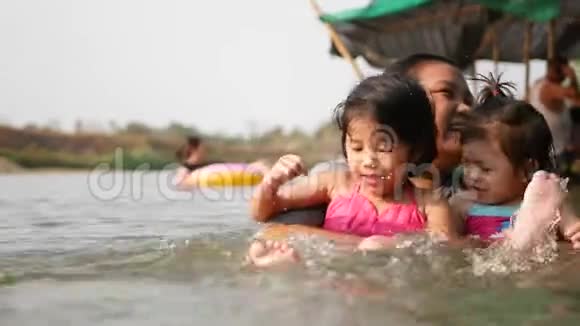 两个亚洲小女孩姐妹喜欢和她的阿姨在河里玩水户外玩耍和大自然接触视频的预览图