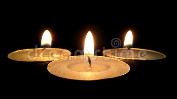 三个燃烧的蜡烛特写黑暗中的烛光视频的预览图