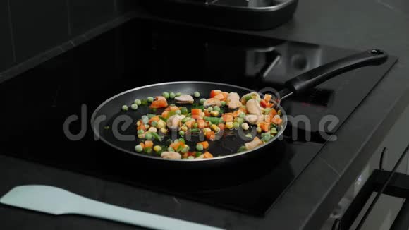 智能现代厨房感应锅上炒菜烹饪过程女人的手在平底锅上准备煮蔬菜海拉尔视频的预览图