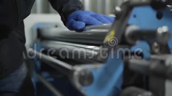 在金属加工的工作手套调整设备中特写男性手使用机械的工人视频的预览图