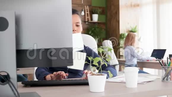 忙碌的年轻商务女性打字享受她的咖啡视频的预览图